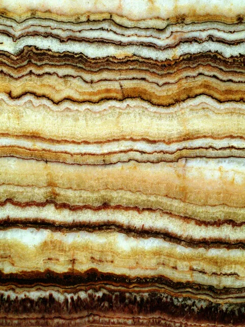 A polished onyx board with bands of honey, cream and brown (reference photo by Kevin Walsh)